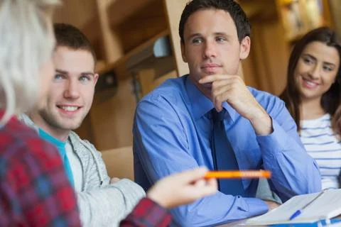 Focused lecturer explaining something to group of students Stock Photos