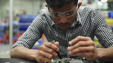 Focused male engineer assembling circuit board in research lab Video stock 220356542