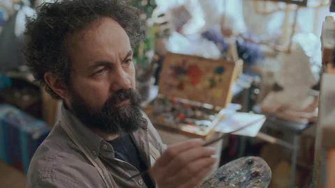 Focused Male Painter Working on Artwork in Creative Studio Stockbeeldmateriaal 330881868
