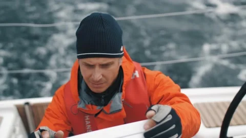 Focused male use digital navigation display panel floating on yacht closeup slow Stock Footage 148156277