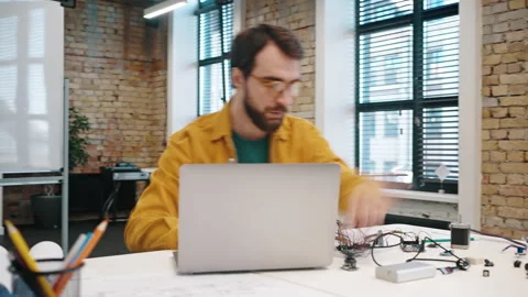 Focused man develops electronic device using modern laptop Vídeos de archivo 219859556