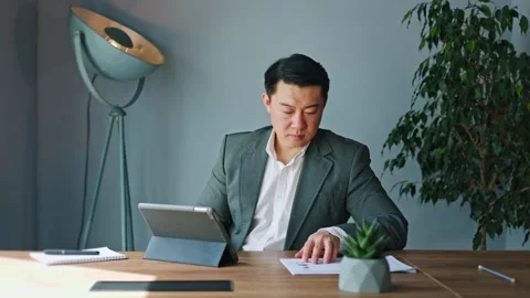 Focused man diligently operating tablet and using stylus in indoors workspace Stock-Footage 275226522