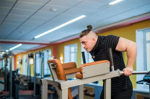 Focused man doing dips in the gym Stock Photos