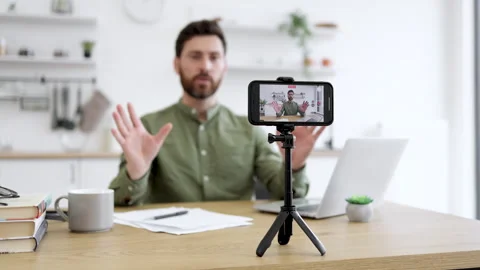 Focused man filming course about meditation on smartphone Stock Footage 253327850