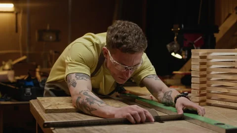 Focused Man Measuring Wood with Ruler in Carpentry Workshop Stock Footage 340401242