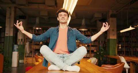 Focused man meditating and levitate on table in modern coworking Stock Footage 322165349
