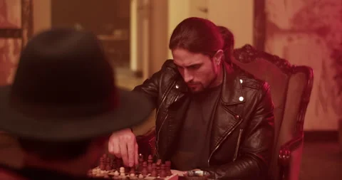 Focused man playing chess with anonymous opponent Stock Footage 260558704