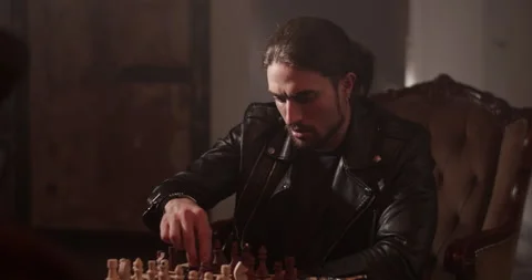 Focused man playing chess board game at home Stock Footage 260557620