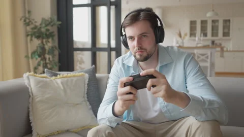 Focused Man Playing Video Game With Headphones, Talking To Teammates Online 스톡 동영상 301247934
