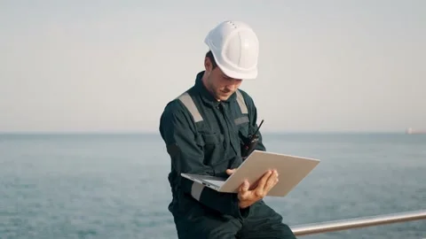 Focused man port inspector using laptop computer while working at dockside Stock Footage 165128326