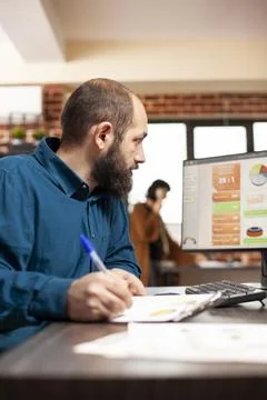Focused man reading research notes Stock Photos