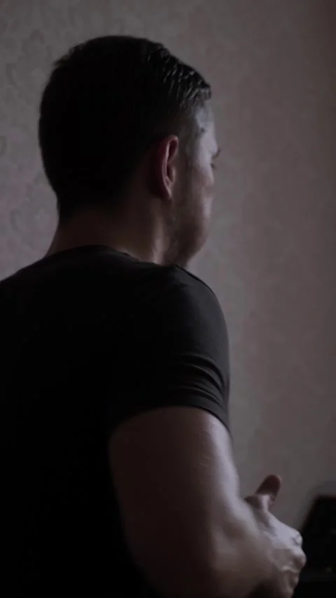 A focused man runs on the treadmill, improving his speed and endurance. Stock Footage 305570324