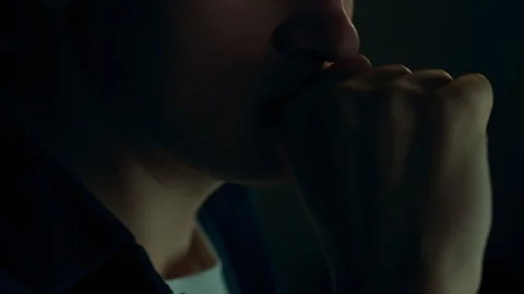 Focused man sitting in front of computer, working at night. His face, in clo 動画素材 255434133