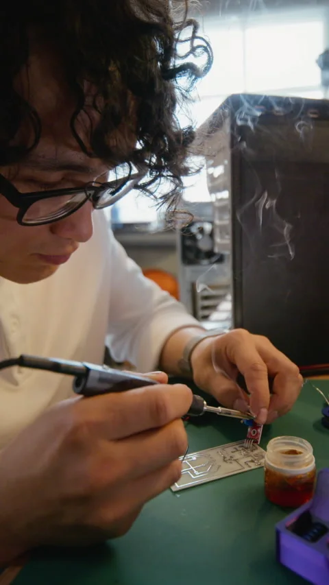 Focused Man Soldering Circuit Board for Hardware Engineering Stock Footage 338422373