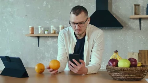 Focused man standing indoors working studying using tablet listening music with Stock Footage 170468690