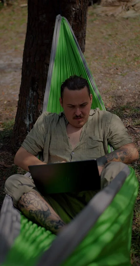 Focused Man With Tattoos Working On A Laptop... Stock Footage 331820844