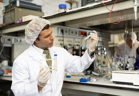 Focused man technician working in research laboratory Stock Photos