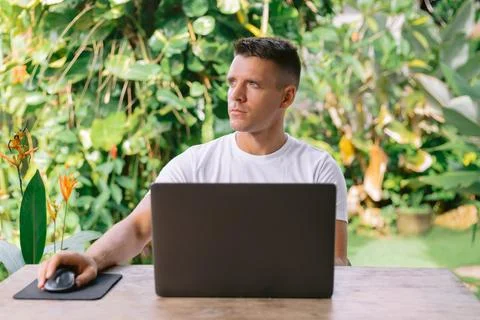 Focused man thinking about new idea with laptop, successful freelancer work.. Stock Photos