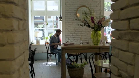 Focused Man Typing on Laptop at Cafe Table Stock Footage 308637024