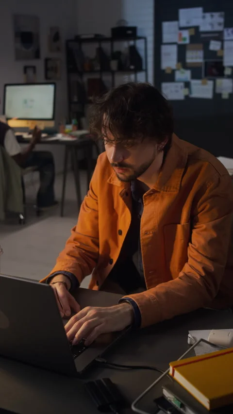 Focused Man Typing on Laptop Working Late in Dark Office Stock Footage 338417748