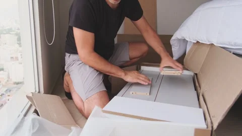 Focused man unboxing and assembling new furniture Stock-Footage 330312785