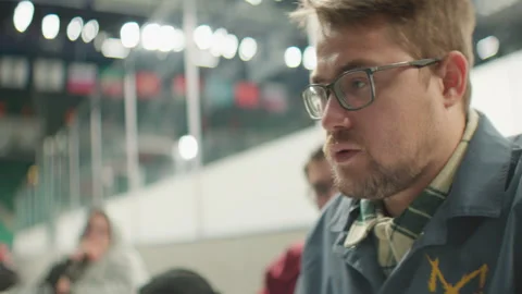 Focused man video editor works on laptop at sports stadium Видео 303068507