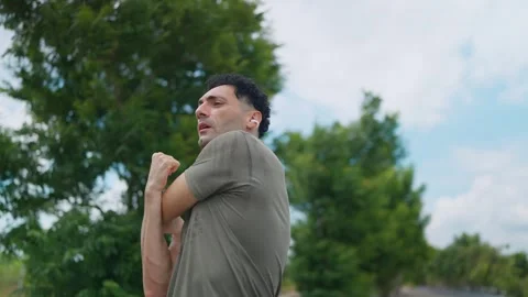 Focused Man Warming Up Before an Outdoor Run Vídeo Stock 345216474