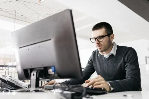Focused man working on computer in the office Stock Photos