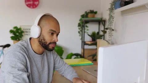Focused man working on desktop computer in home office environment Stock Footage 347219316