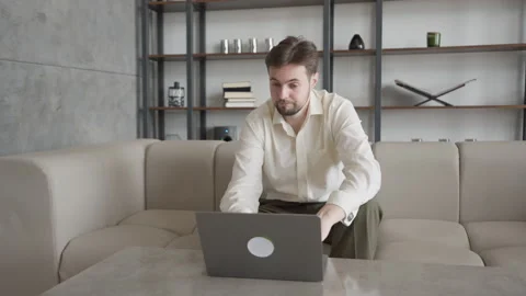 Focused Man Working On Laptop In Office, Pausing To Think Over Challenging Task Stock Footage 304581679