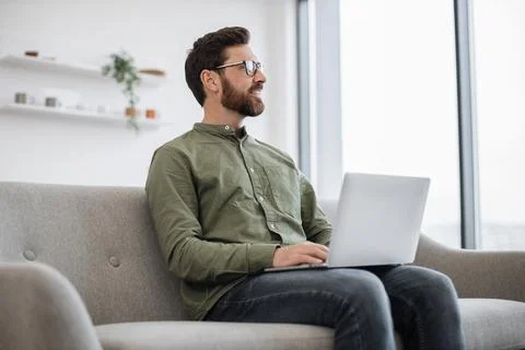 Focused man working on laptop while staying at home 스톡 사진