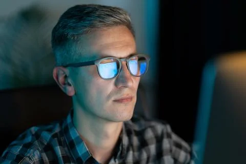 Focused Man Working Late at Computer in Dark Room Stock Photos