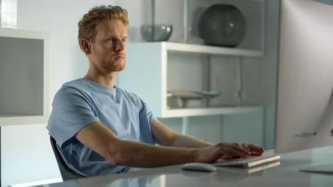 Focused manager surfing web at workplace closeup. Ginger man checking data. Stock Photos