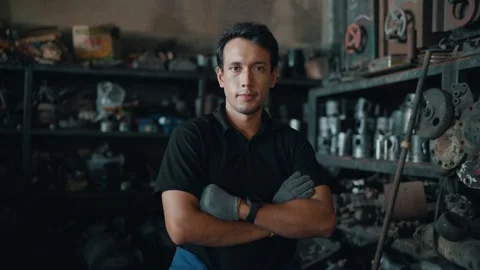 Focused mechanic stands in cluttered workshop Stock-Footage 345031692