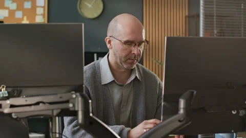 Focused Middle-Aged Male Programmer Developing Software on PC in Office Stock-Footage 306838990