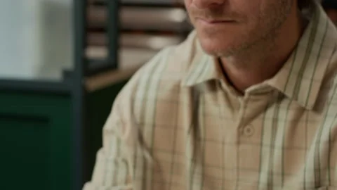 Focused Middle-Aged Male Programmer Coding on Laptop in Modern Office Stock Footage 319994460