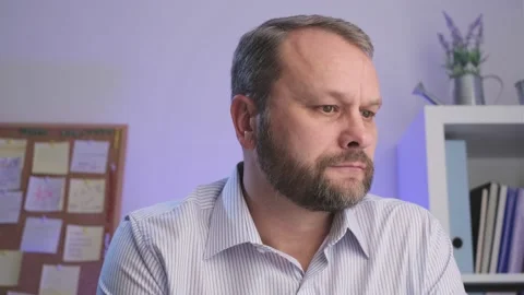 Focused Middle aged man Make using a computer at Home office close up webcam  Video stock 168633292