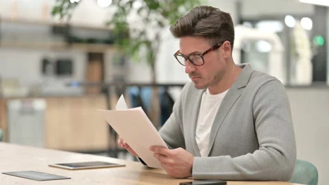 Focused Middle Aged Man Reading Documents Stock Footage 139270406