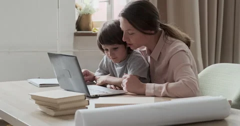 Focused mother and boy working together on the computer, learning programs Stock-Footage 164969836