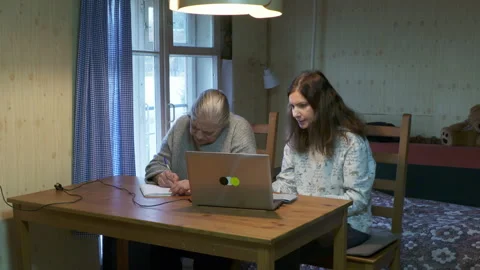 Focused Mother And Daughter Solving Problem On Laptop At Home Stock Footage 322059201