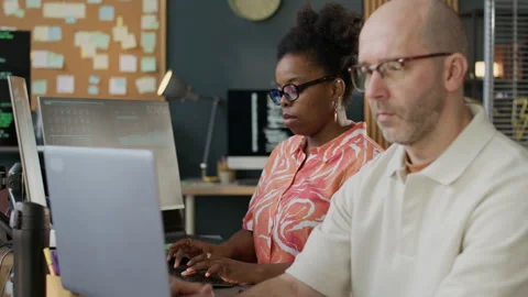 Focused Multiethnic Team of Programmers Coding on Computers in Office Stock-Footage 306843073