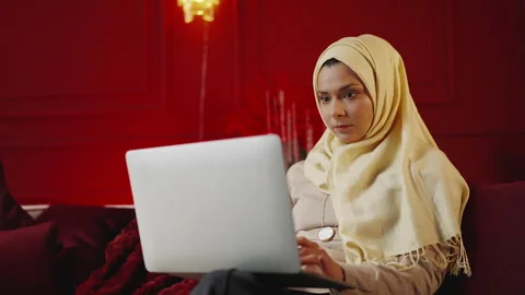 Focused Muslim freelancer types on laptop while working online from home Stock Footage 343985156