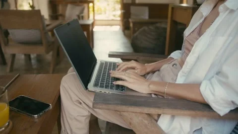 A Focused Pair of Hands Swiftly Typing on a Laptop While Seated Outdoors in Stock Footage 280848478