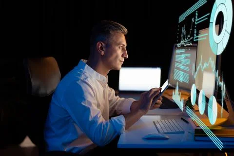 Focused Professional Analyzing Data on Digital Display at Office Desk Stock Photos