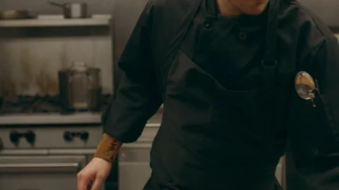 Focused professional chef taking fillets of salmon and cutting them into serving Stock Footage 199459069