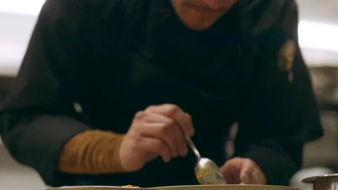 Focused professional chef using a circular ring to shape a stack of salad in a b Video stock 199459738