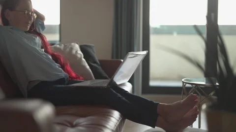 A focused professional is diligently working remotely while sitting on a laptop Stock Footage 289966229