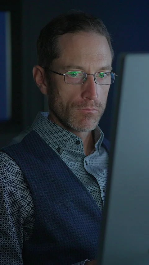 A Focused Professional Engaged in Work on a Computer Late at Night in the Stock Footage 295225959
