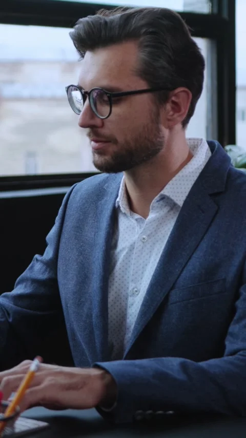 A Focused Professional Excelling in a Modern Office Setting with Innovation and Stock Footage 303666479