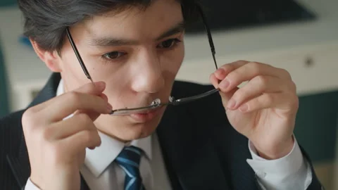 Focused professional preparing. Young Asian worker reviewing notes carefully Stock Footage 342059689